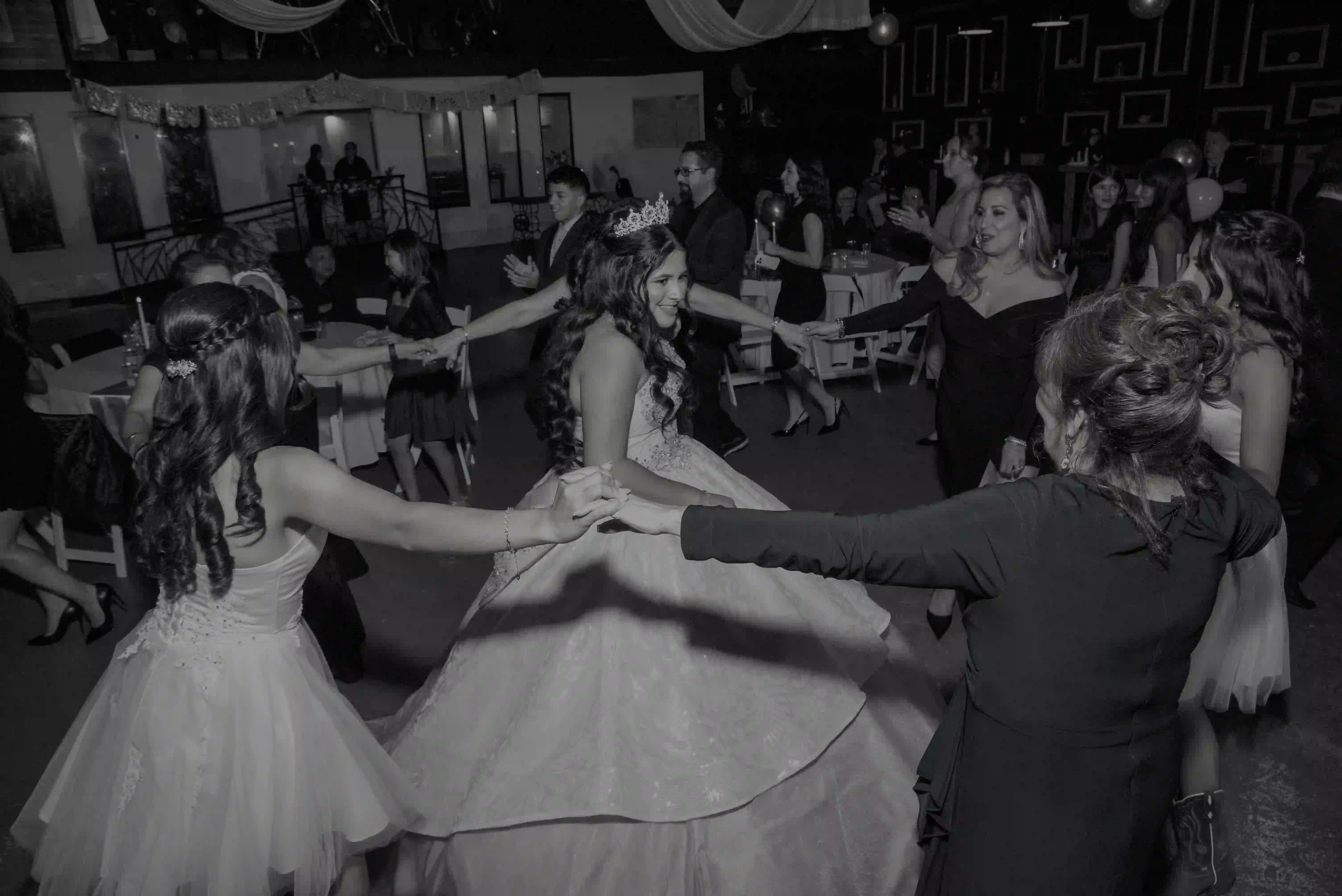 Guests circling the quinceañera on the dance floor