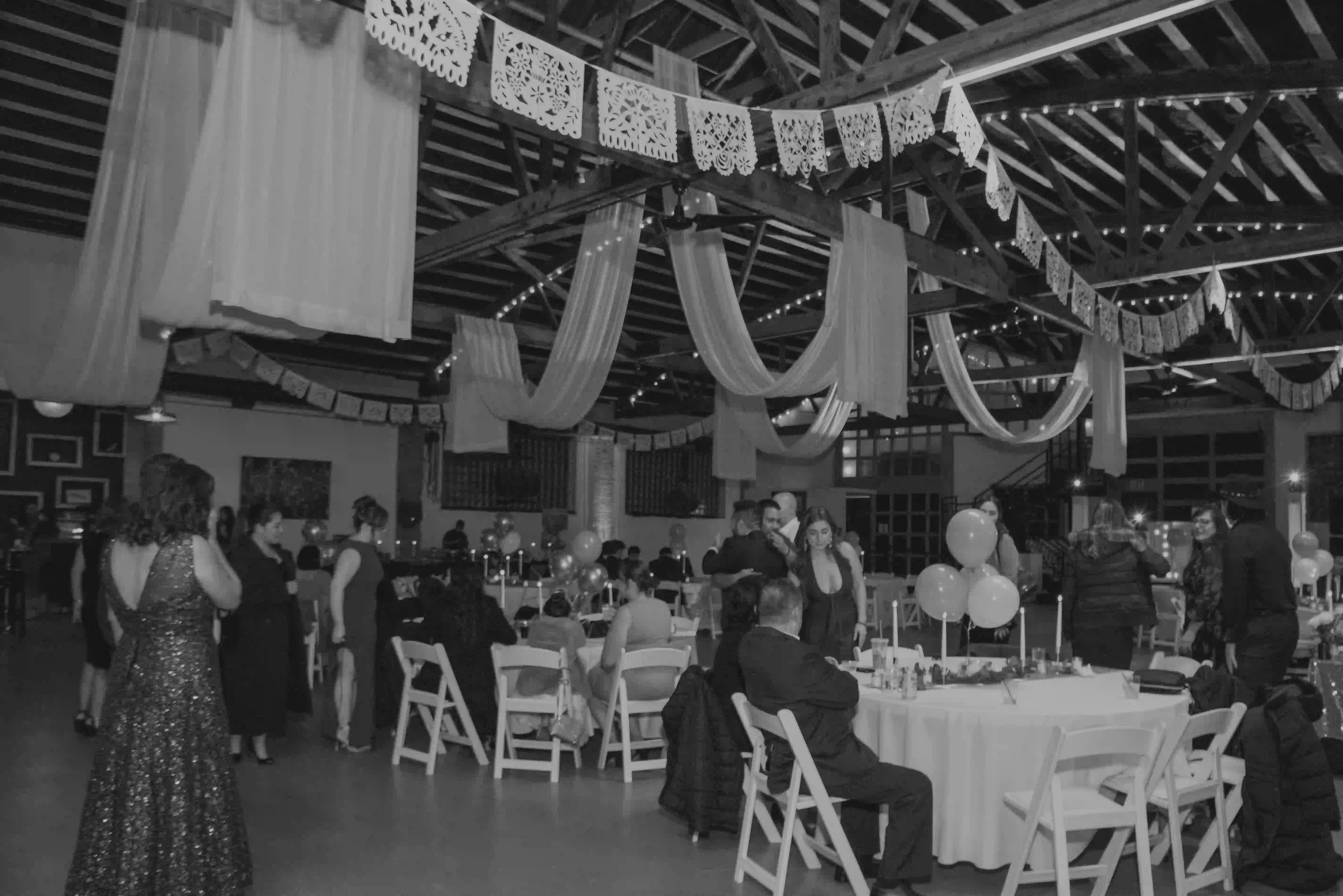A full reception under papel picado and string lights